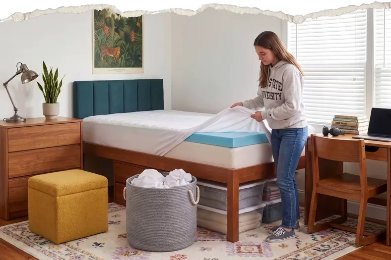 College boy on his floor with his back to school items