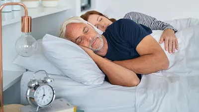 middle aged man sleeping on the couch